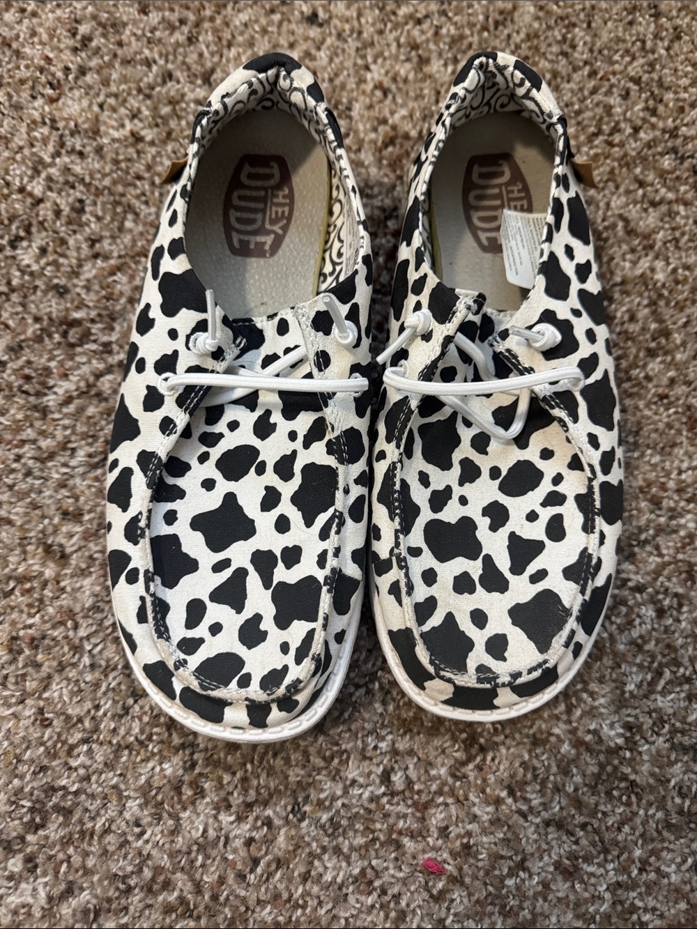 Hey Dude Sz 8 Woman’s Cow Spot Slip-On Sneakers - Black & White 
Worn 1 time
